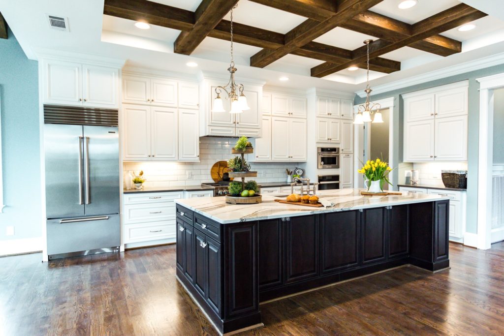 Modernized kitchen with hanging ceiling lights over island